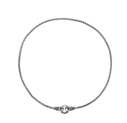 A simple sterling silver clavicle necklace with a small pendant, shown on a model.