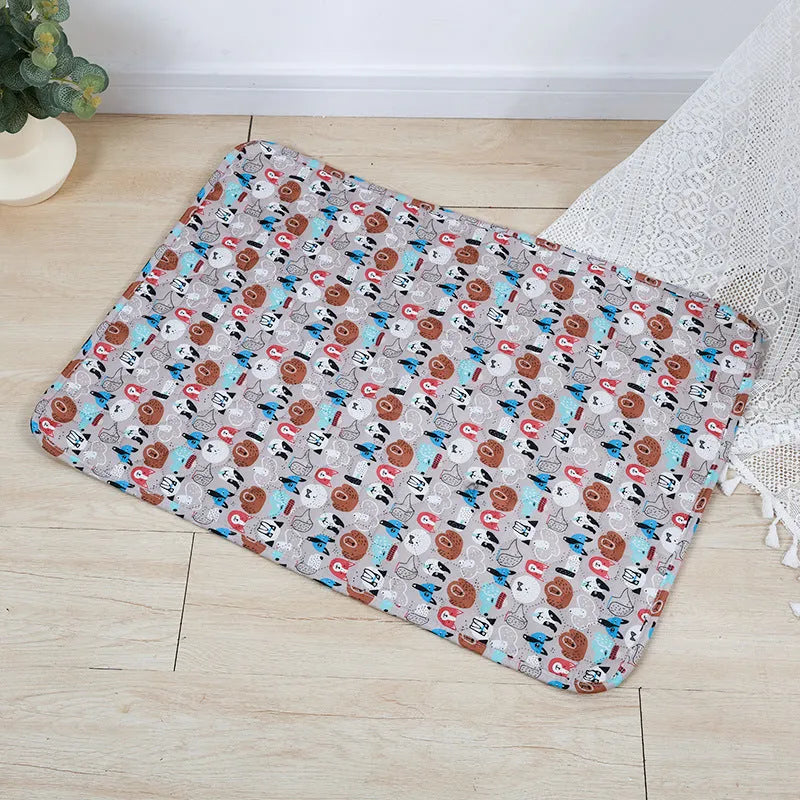 Reusable washable pet urine pad showing colourful animal pattern and waterproof backing.