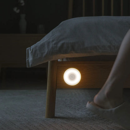 White Mijia Bluetooth bedside lamp with human body sensor on a wooden table.