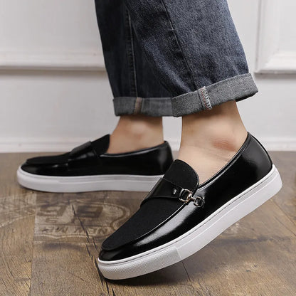 Men's black slip-on shoes with a gold horsebit buckle detail and round toe.