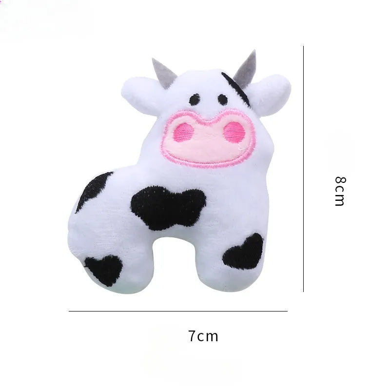 Plush cat toy in cow, crocodile, or parrot shape with colourful fabric and embroidered details.