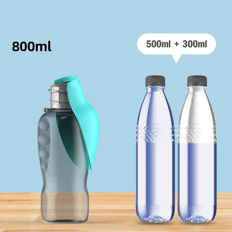 Blue grey portable dog water bottle with fold-out drinking bowl, shown with a wrist strap.