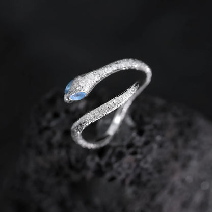 Platinum colour adjustable snake design ring for women on a neutral background.