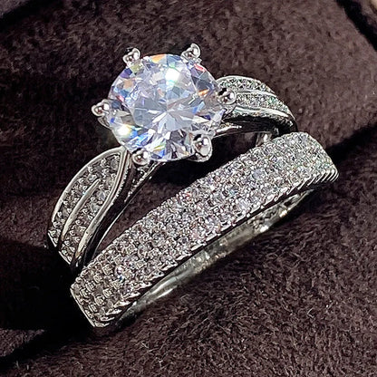 White gold-coloured geometric wedding ring with round elements on a finger