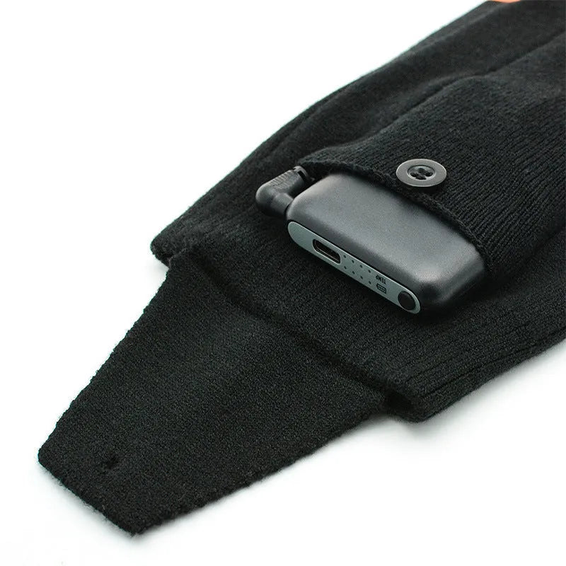 Black and grey mesh smart heating socks with USB cable and battery for skiing.