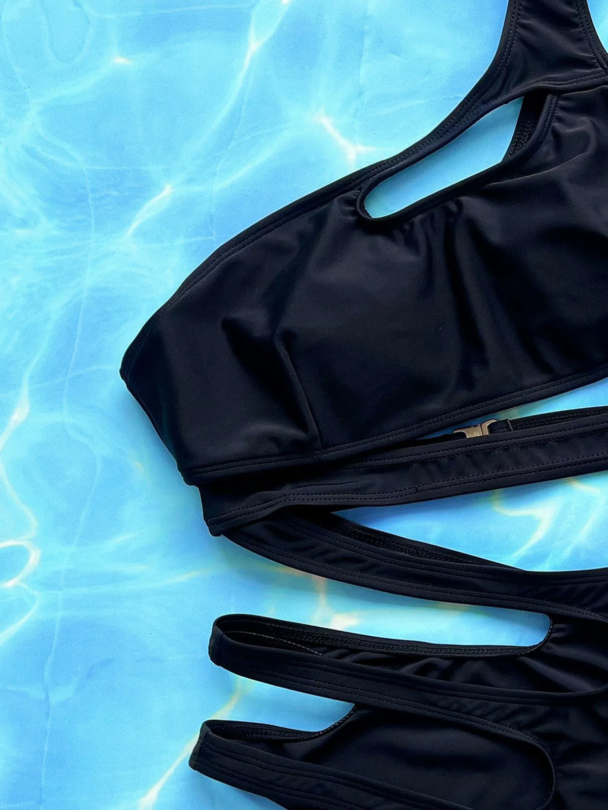 Women's black one-piece swimsuit with hollow out strap design for swimming