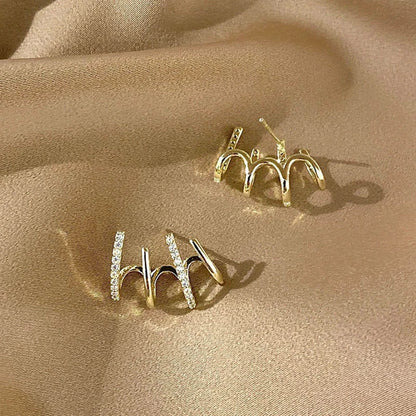 Pair of 925 sterling silver earrings with four-prong zircon stone settings in a geometric design