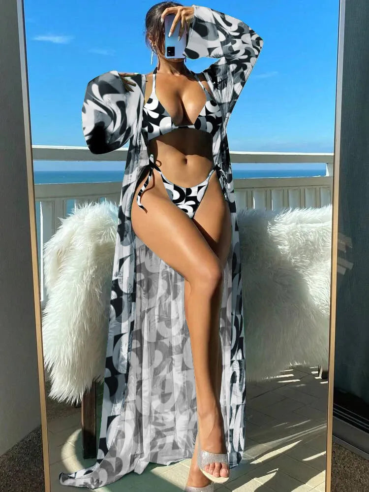 Polyester banded bikini set with long sleeve blouse, briefs, and robe cover-up in floral pattern