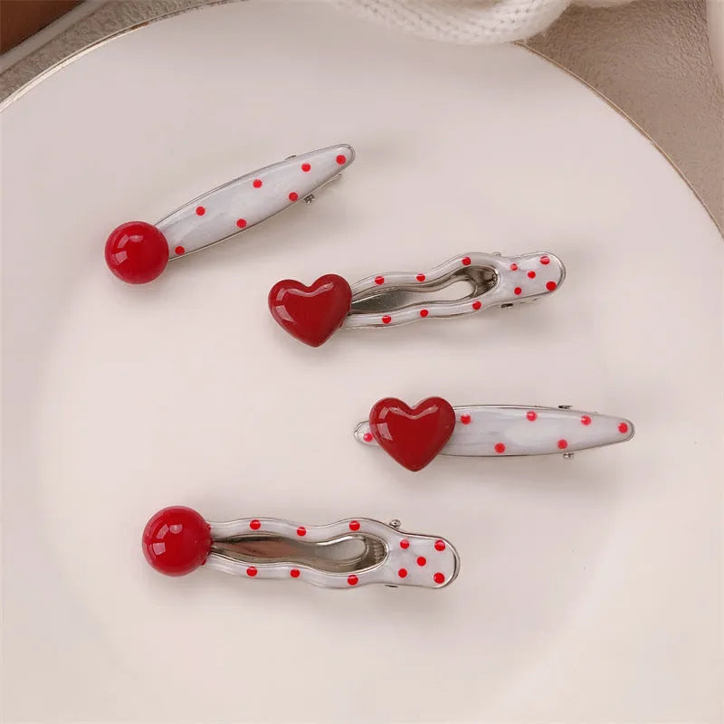 Red love heart-shaped hair barrette clip with retro white dots on a willow leaf-shaped base.