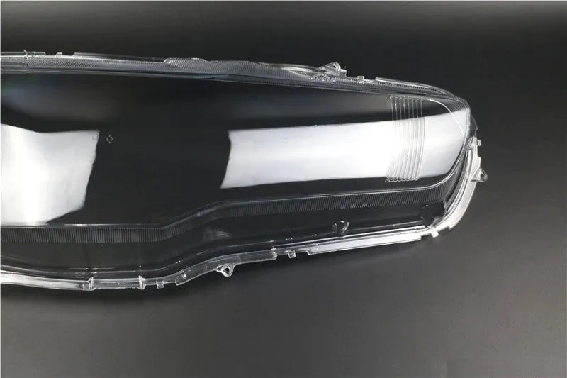 Transparent plastic car headlight housing cover with dimensions 50mm by 30mm by 20mm.