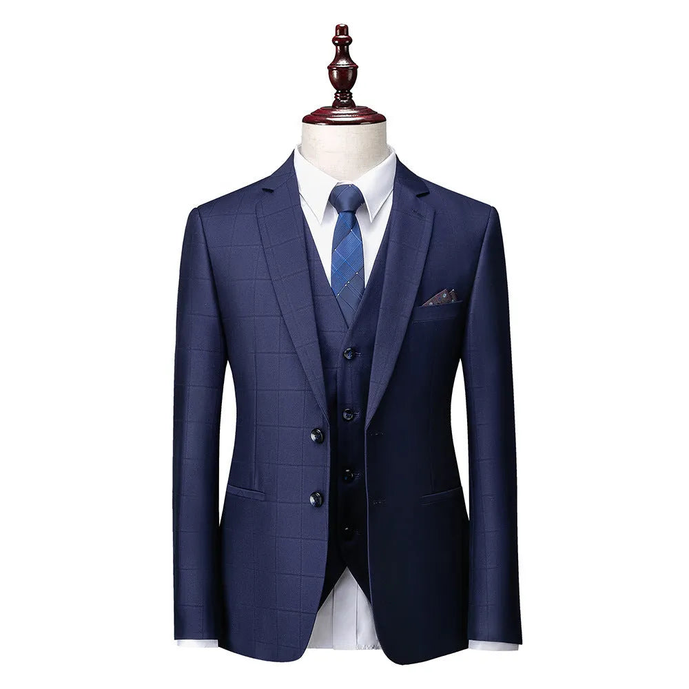 Man wearing a navy blue plaid slim-fit three-piece suit with jacket, waistcoat, and trousers