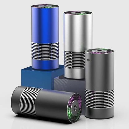 Compact black car air purifier with aluminium alloy and ABS construction, shown next to a car USB port.