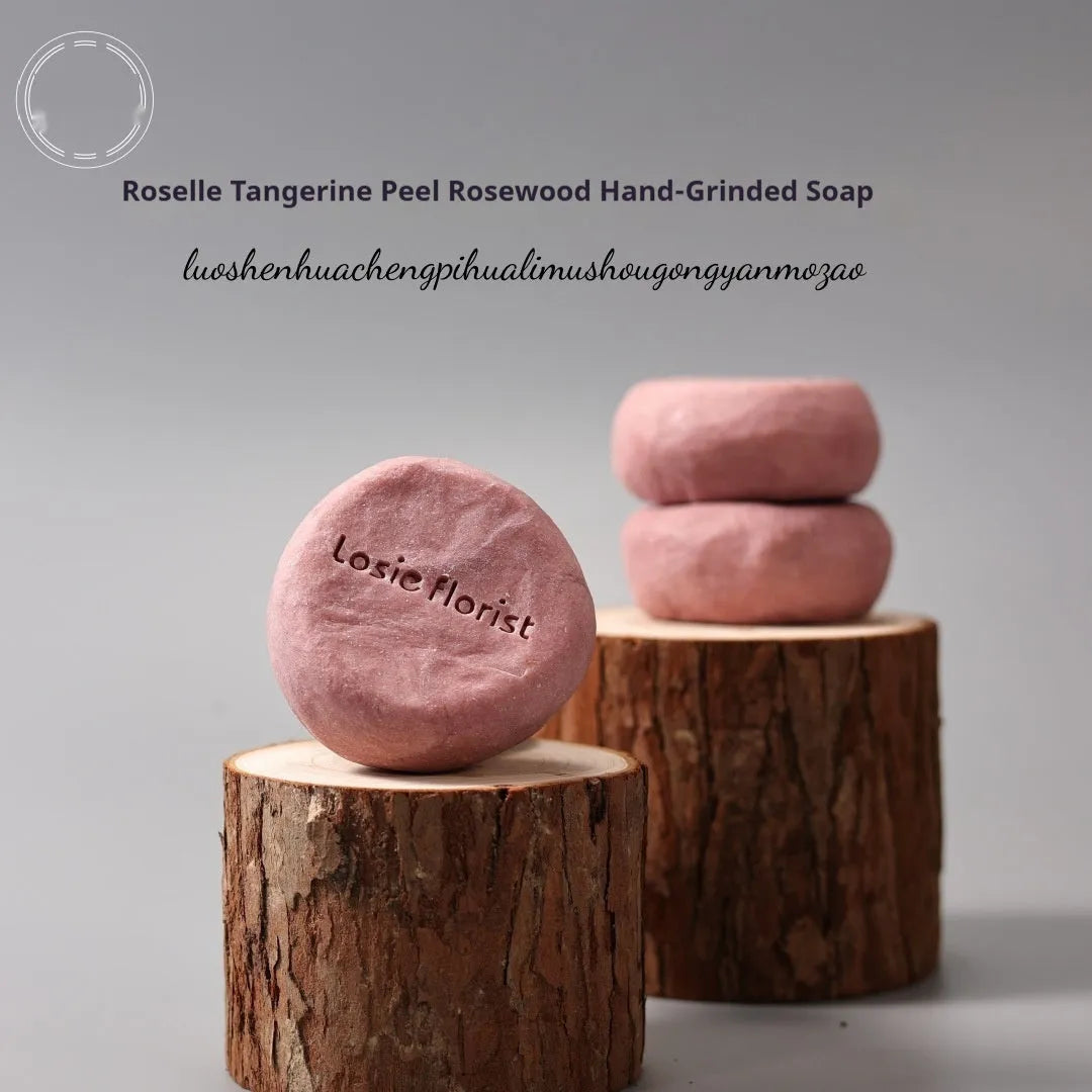 Pink round handmade rosewood grinding soap with roselle and tangerine peel ingredients