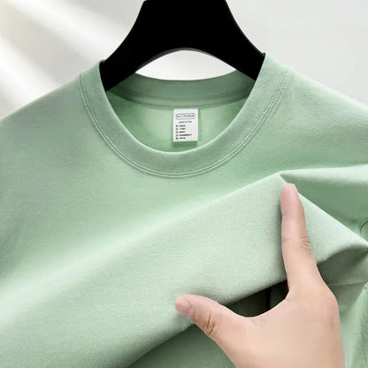 Men's thin cotton drop shoulder t-shirt on a hanger, shown in a light colour.