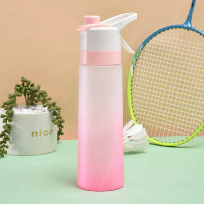 White spray water bottle with black leakproof lid and handle strap on a table