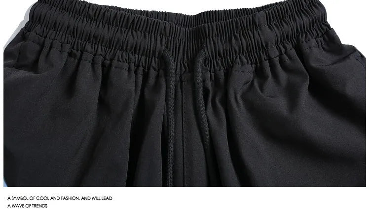 Loose-fit black sports shorts with elastic waistband and straight-leg cut for athletic wear