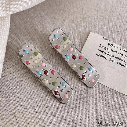 Silver metal hair barrettes with hollow heart pattern and duckbill clip design