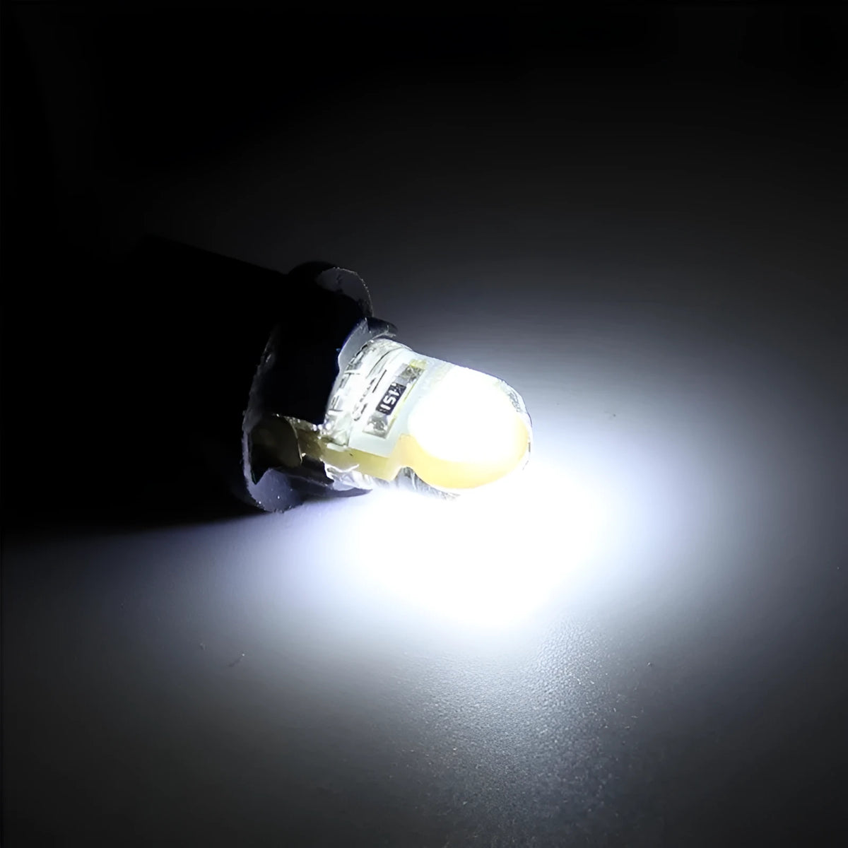 Pack of ten T10 wedge base LED car bulbs with COB chips in various colours on a white background
