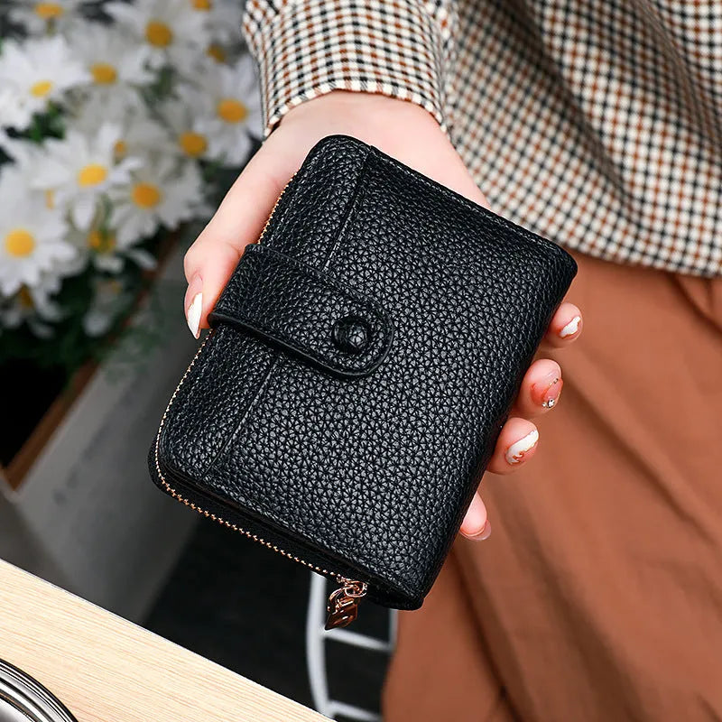 Women's solid colour PU short wallet in beige, showing lychee pattern and sewing thread detail.