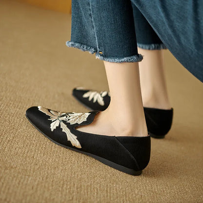 Women's embroidered low-cut flat pumps in beige with a round toe and soft sole.