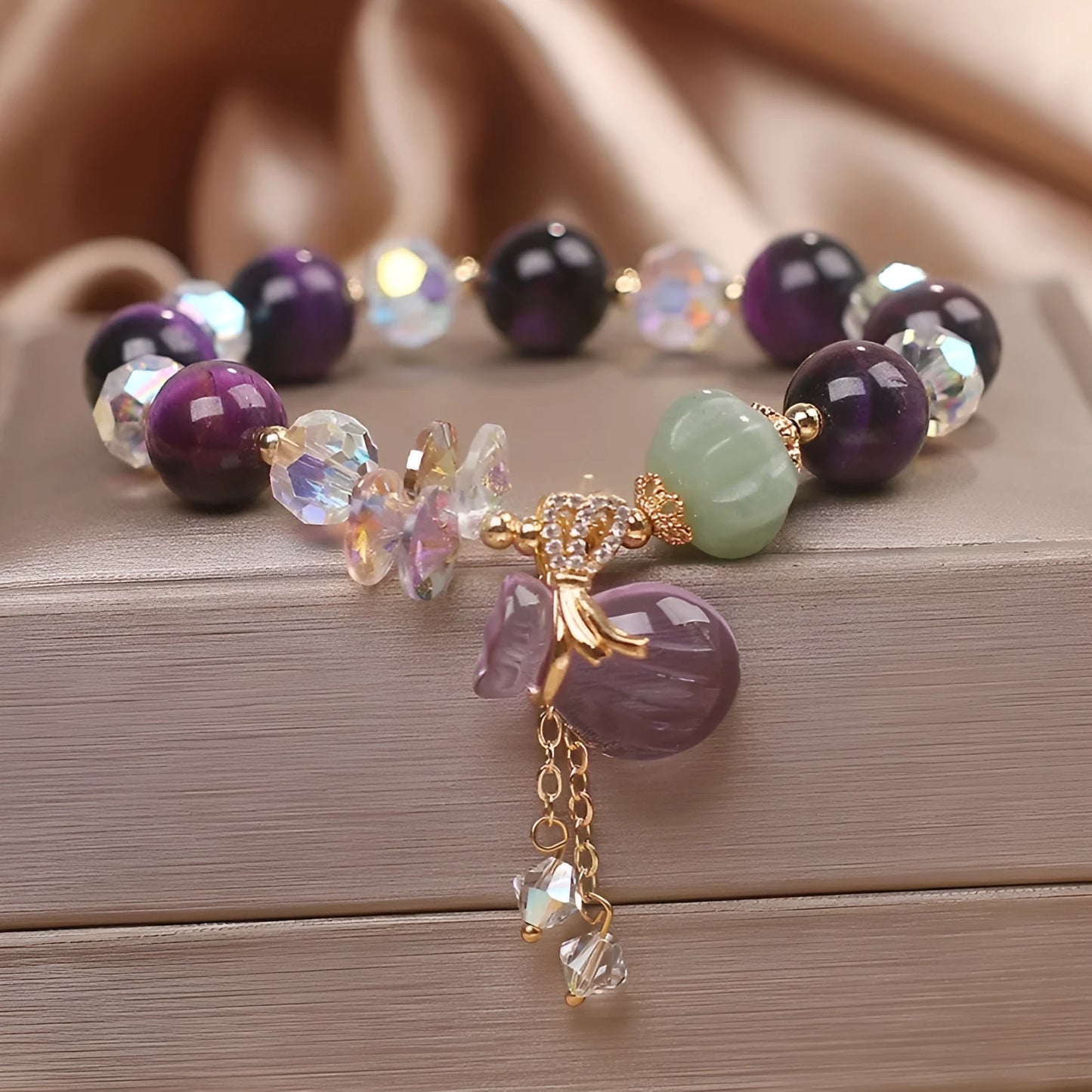 Women's crystal bracelet with purple tigereye money bag pendant and rhinestone decorations