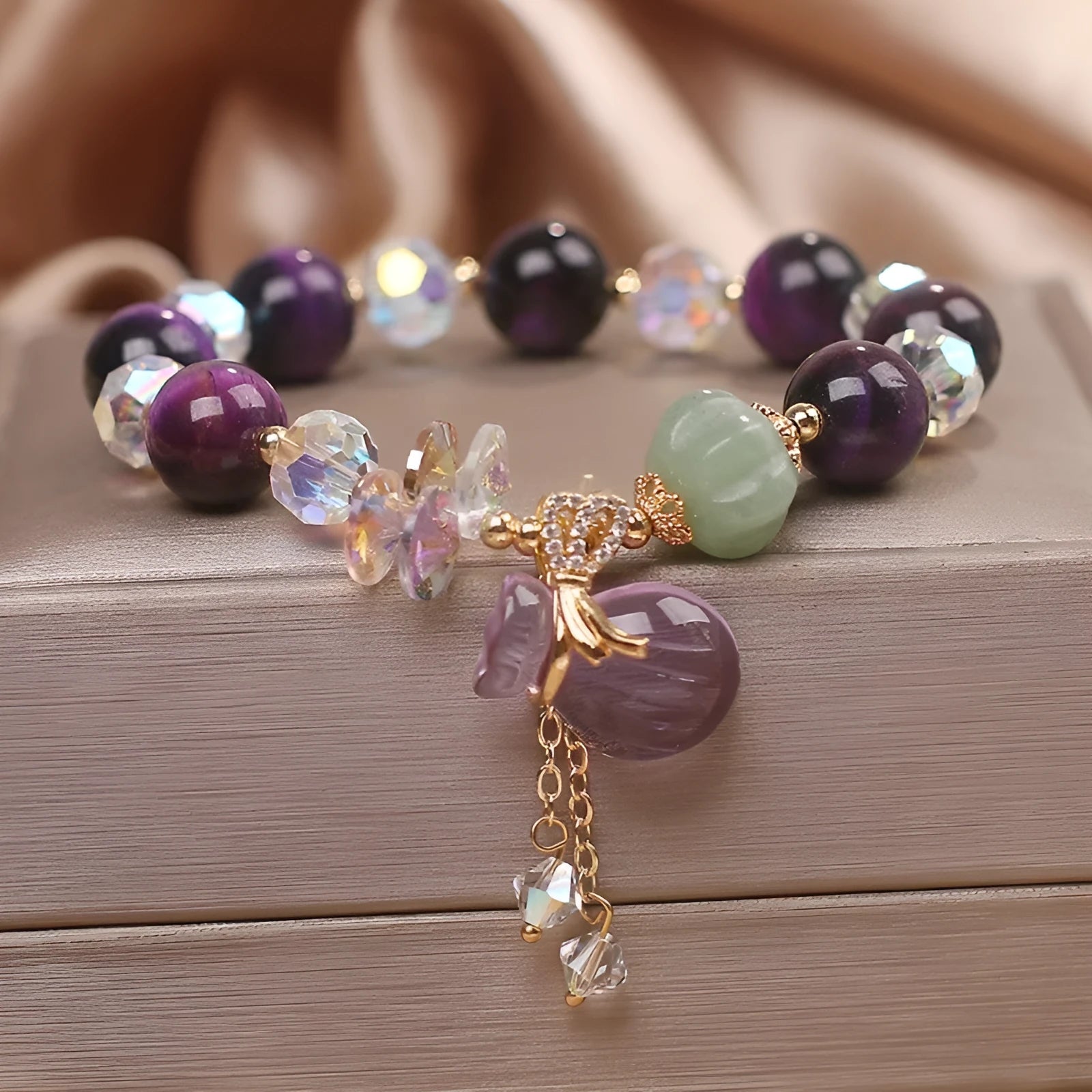 Women's crystal bracelet with purple tigereye money bag pendant and rhinestone decorations
