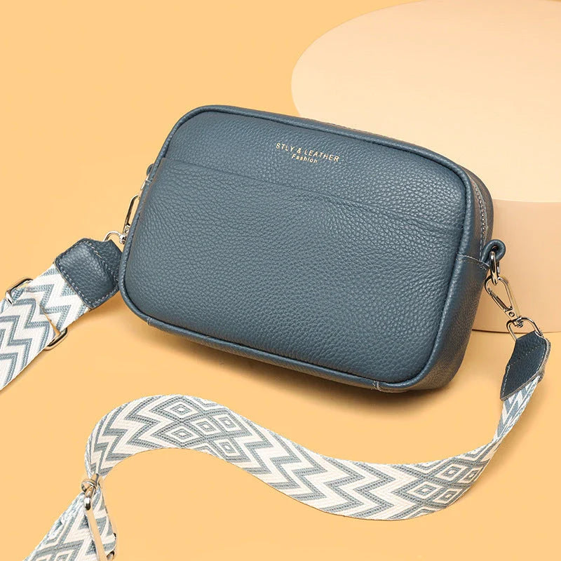 Stylish crossbody bag with rhombus embroidery, wide adjustable shoulder strap, and multiple interior pockets in various color options