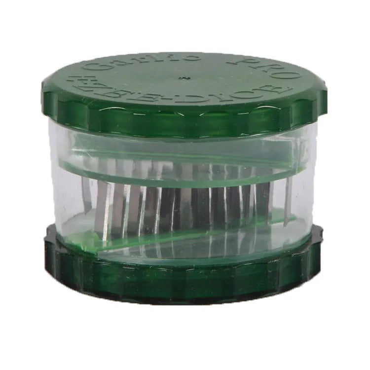 Transparent green garlic peeler measuring 8.5 by 8.5 by 6 centimetres with garlic cloves visible inside