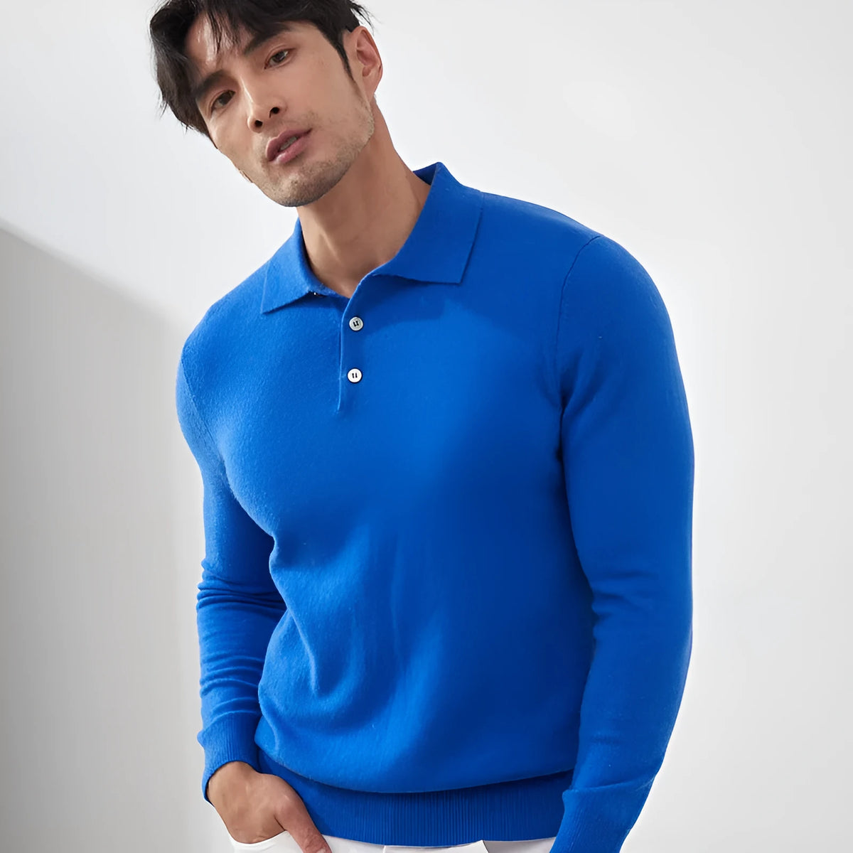 Men's cashmere pullover sweater with polo collar in loose fit on a hanger