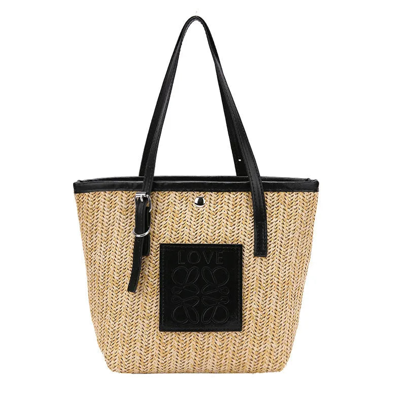 White woven straw women's shoulder bag with a three-dimensional pocket and a black handle.