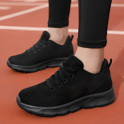 Women's black mesh running shoes with cross-strap and 3-5cm wedge heel, fabric upper with sewing details