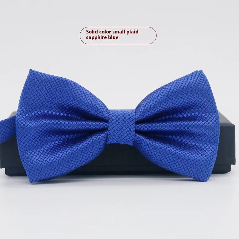 A solid colour pre-tied bow tie with an adjustable neck strap, shown in a classic flat head shape.