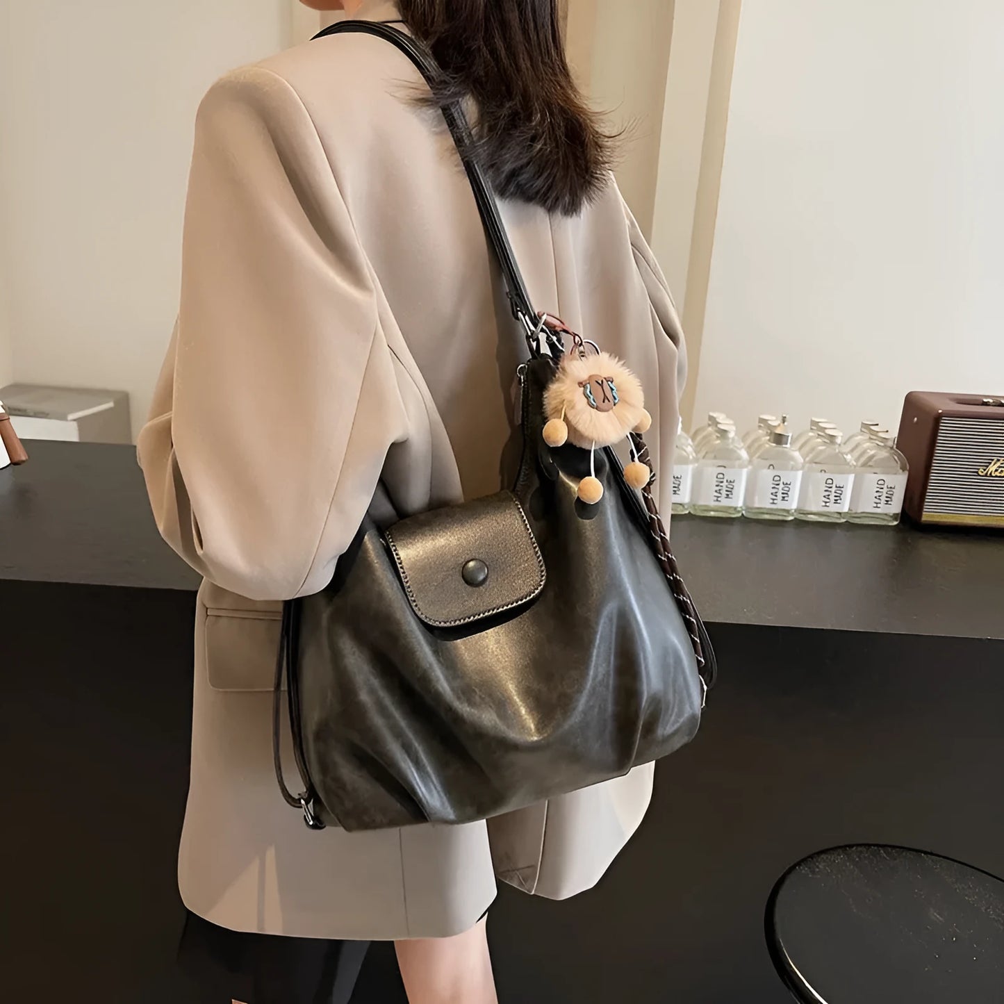 Women's leather shoulder bag with single strap and horizontal square shape in black colour