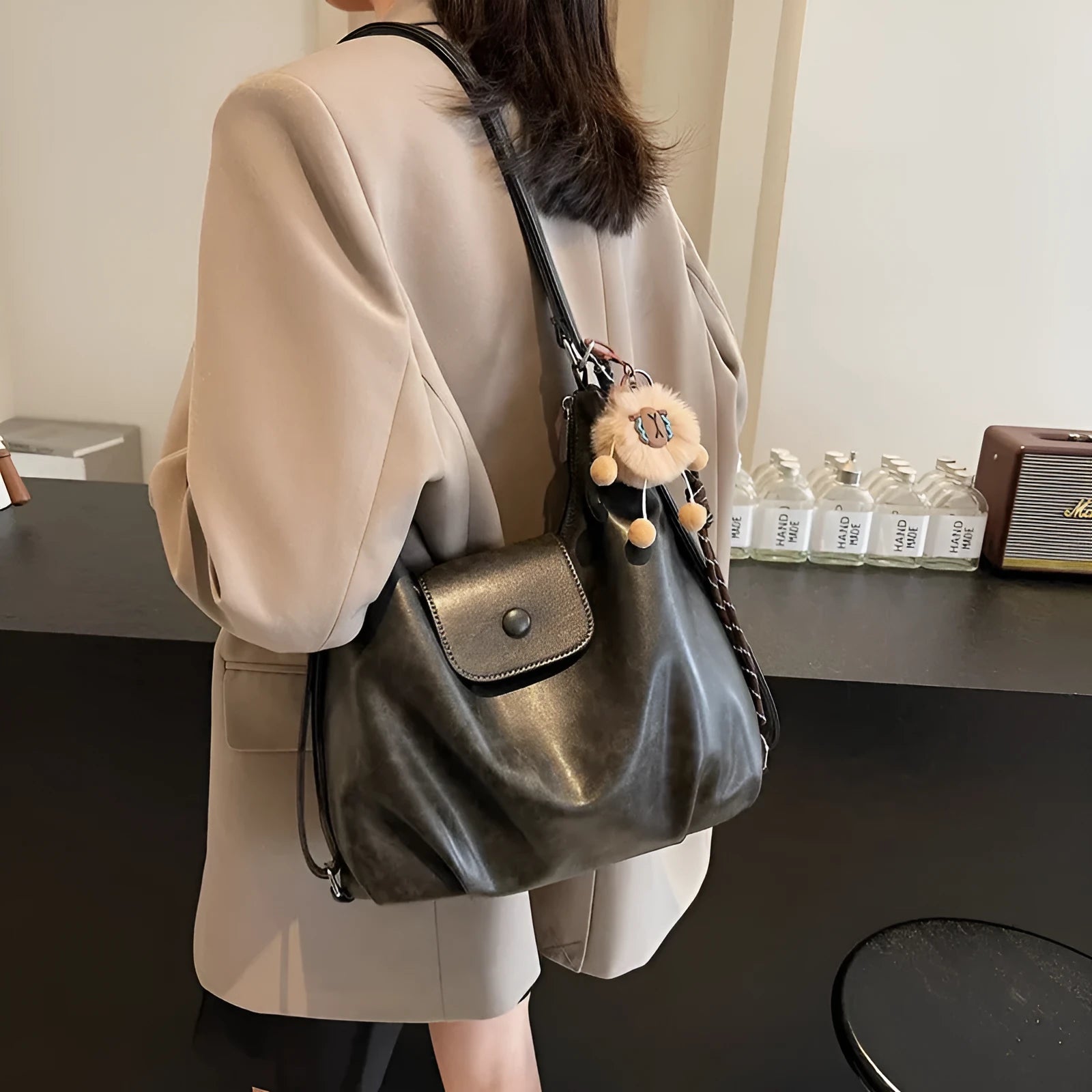 Women's leather shoulder bag with single strap and horizontal square shape in black colour