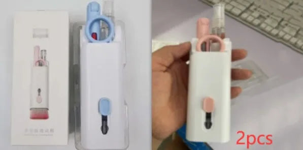 White electronics cleaning kit with a cleaning pen, spray bottle, brush, and keycap puller on a table