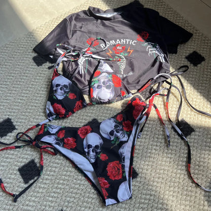 Women's three-piece swimsuit set with skull rose print in red colour showing bikini top, shorts, and short sleeve top