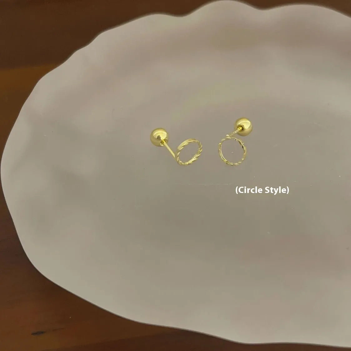 Pair of small spiral geometric ear studs with gold hollow thread finish in mixed material, shown in eight shape options.