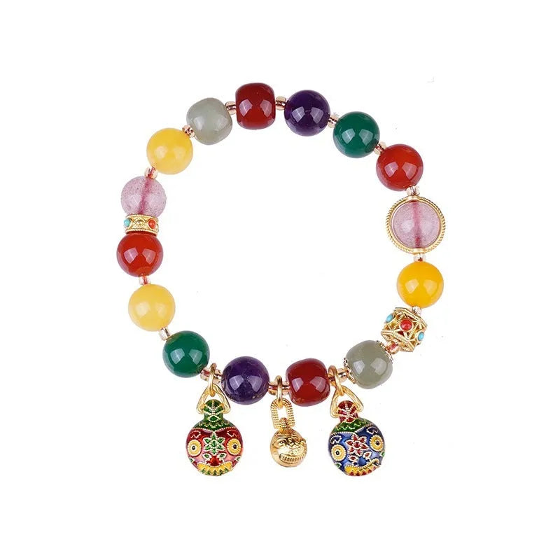 Hand-woven agate bracelet with 10mm beads and a detailed swallowing gold beast charm.