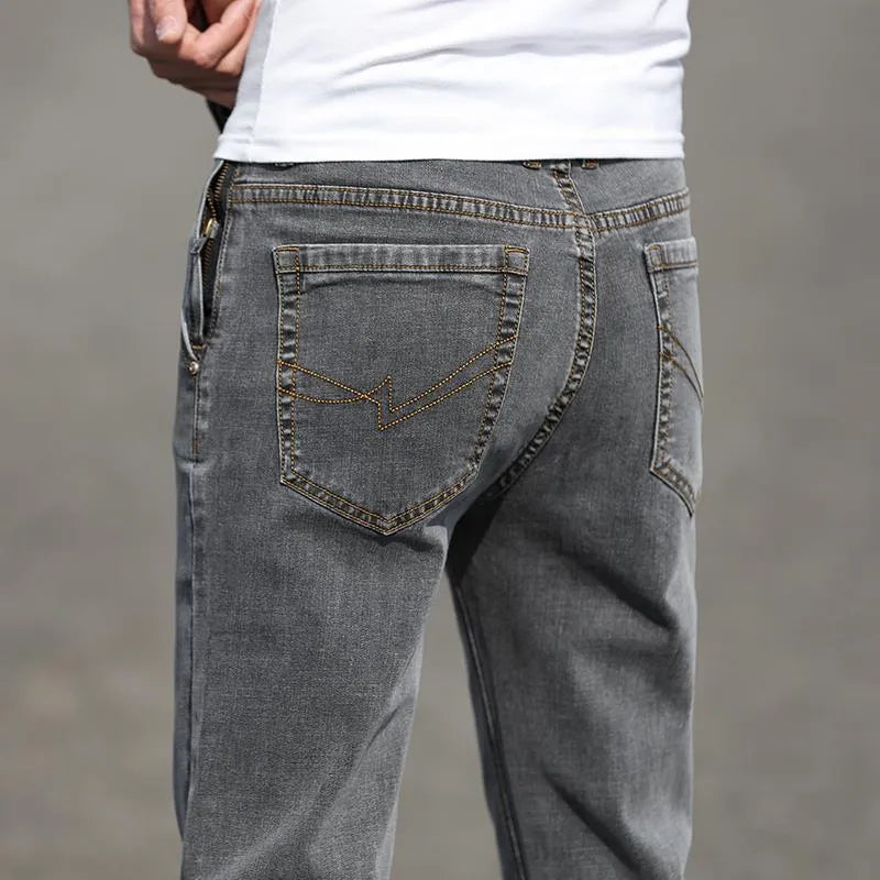Men's smoky gray straight leg jeans with high elasticity fabric and low waist design