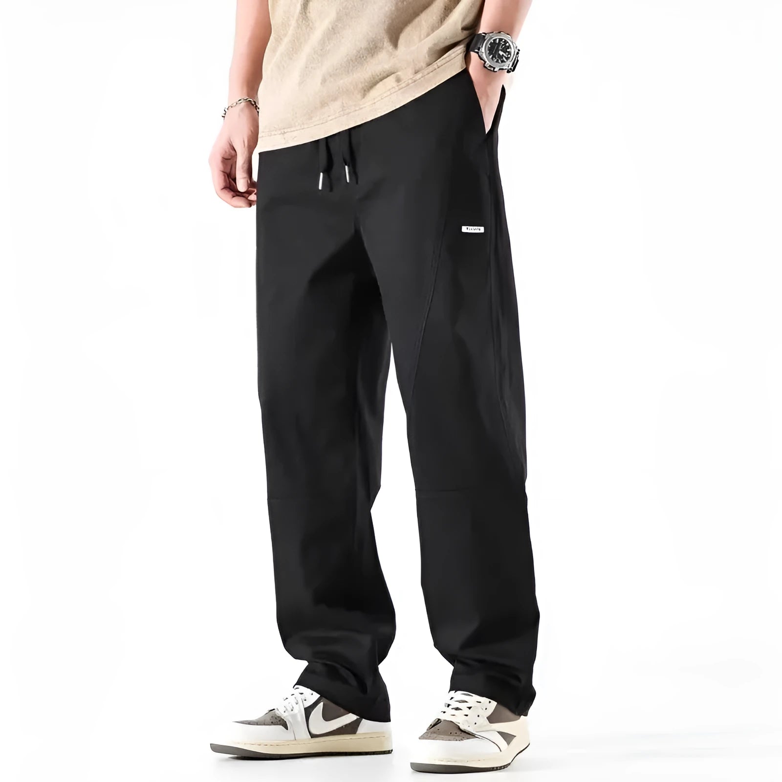 Beige cotton wide-leg trousers with an elasticated waistband laid flat.