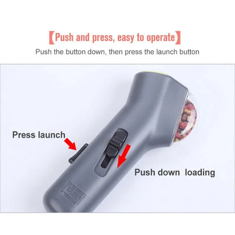 Grey-coloured pet treat catapult launcher for dogs and cats on a plain background.