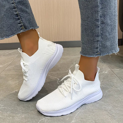 Women's Flyknit mesh running shoes in milky white with a low flat heel and rubber sole