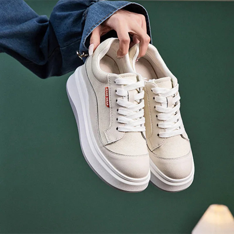Women's pink leather board shoes with thick height-increasing sole on beige background
