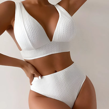 White women's backless bikini swimsuit with brief cut, laid flat showing bra and panties.