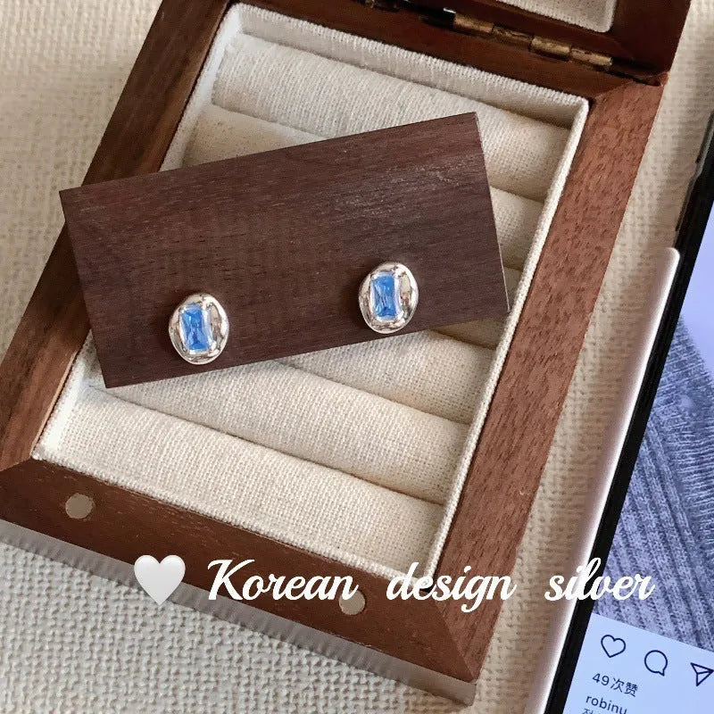 Women's S925 sterling silver oval blue diamond heart-wrapped earrings with electroplated silver finish