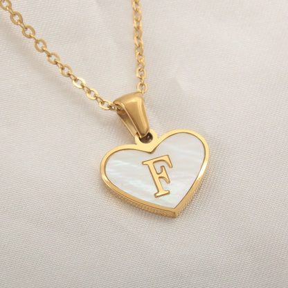 Gold-plated heart necklace with white shell pendant showing letter personalisation option