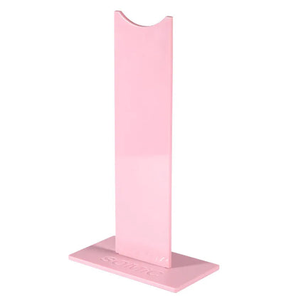 Pink and black detachable headset stand with non-slip silicone base on a desk.