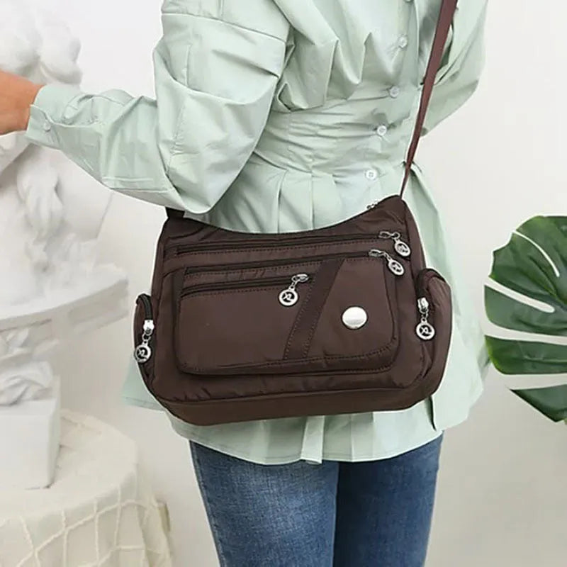 Women's nylon shoulder bag with multi-pocket design, zip opening and detachable handle in red, purple, black or army green