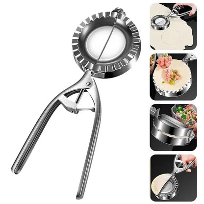Silver stainless steel manual dumpling press with hinged handles on a wooden kitchen surface.