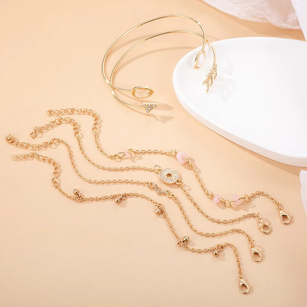 Six golden spot drill bracelets with arrow, water drop and V-shaped pendants on zinc alloy chains